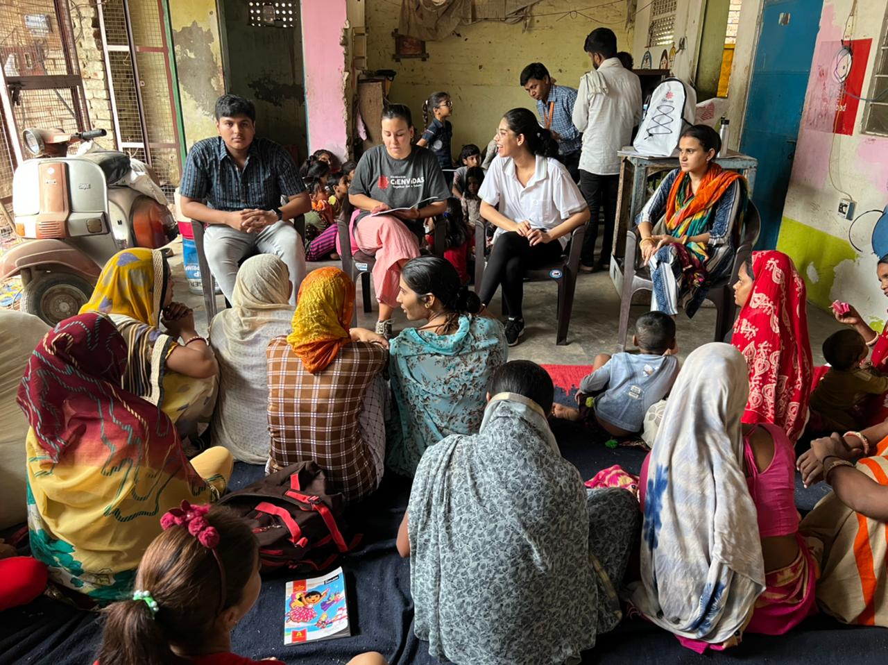 Volunteer teaching adult mothers in a women's empowerment workshop in Jaipur