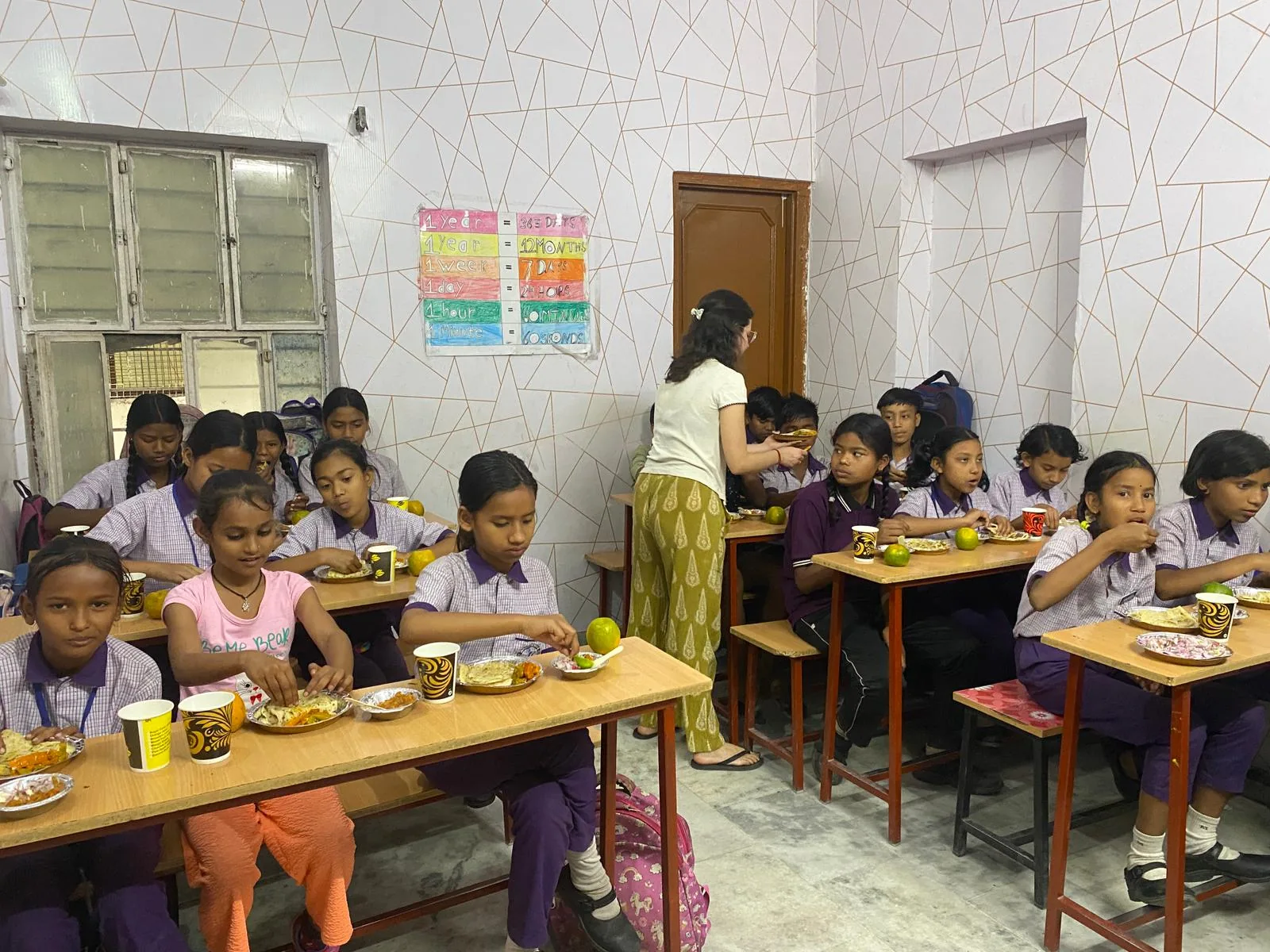Niños comiendo en el comedor de la escuela durante el voluntariado en Jaipur, India