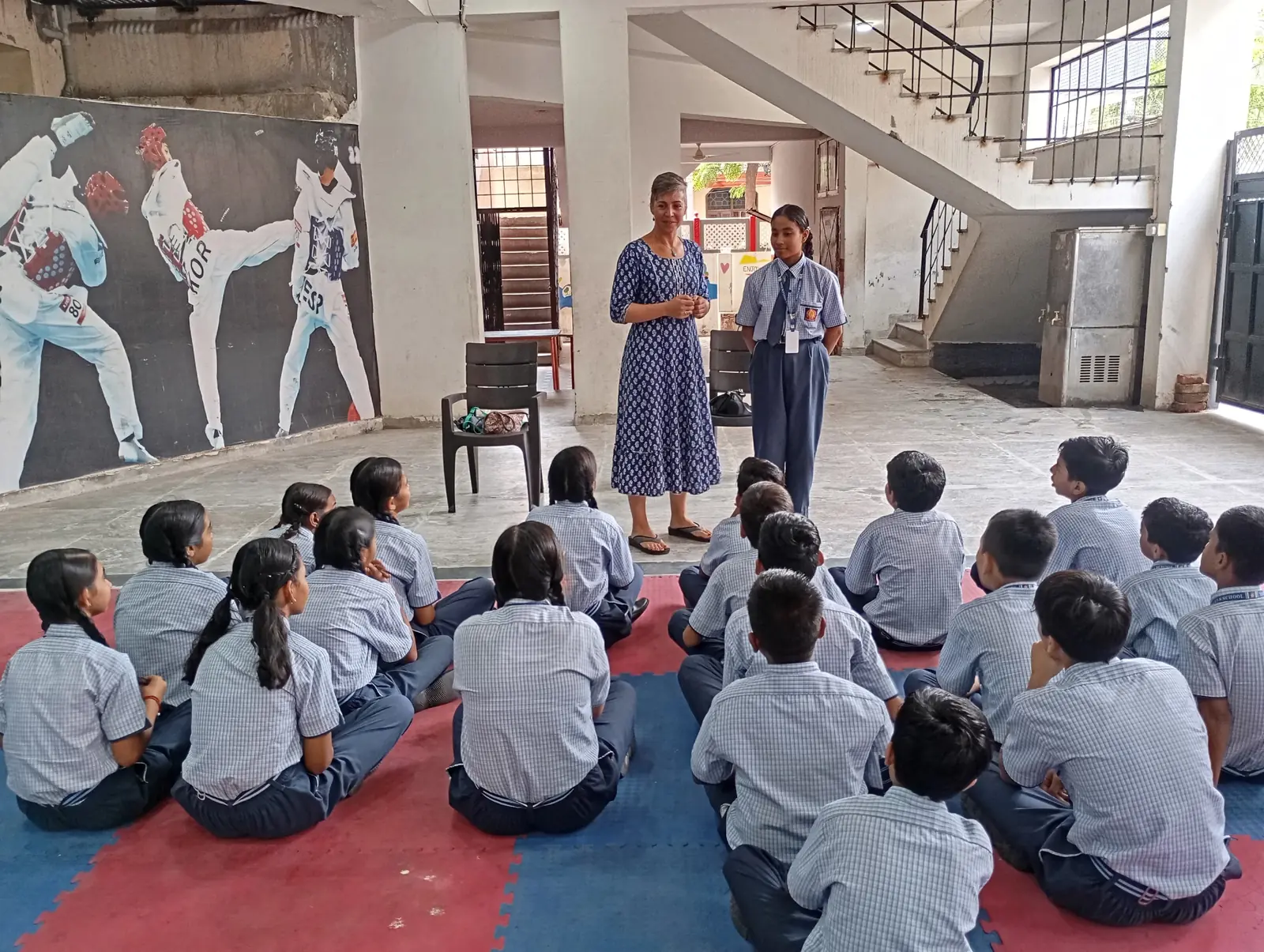 Volunteer giving an educational talk to children in India