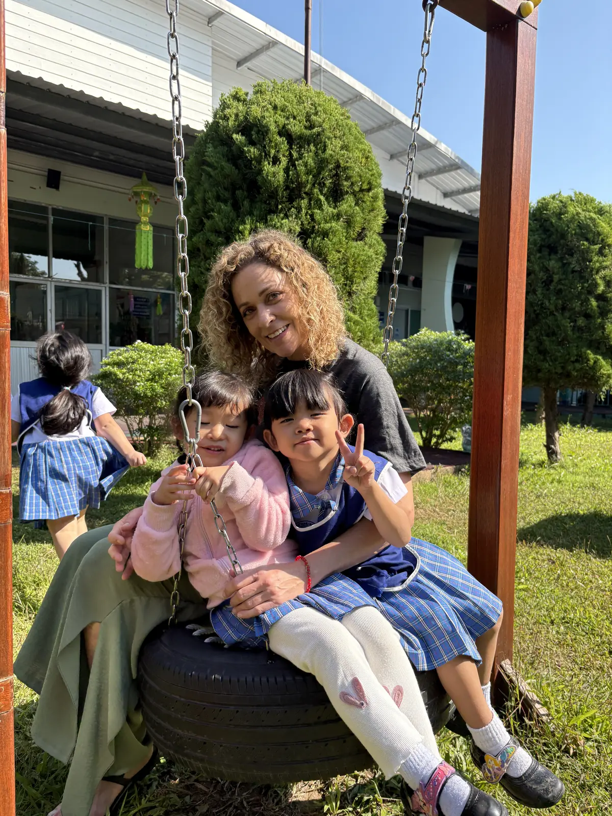 Girls on a swing during a volunteer programme in Thailand