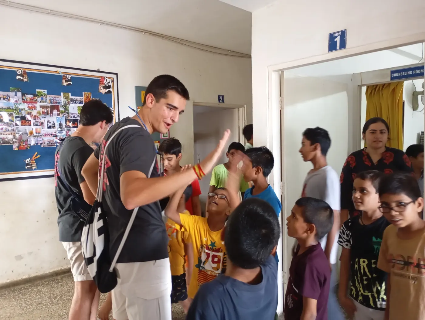Young volunteer running activities with children at a school in India