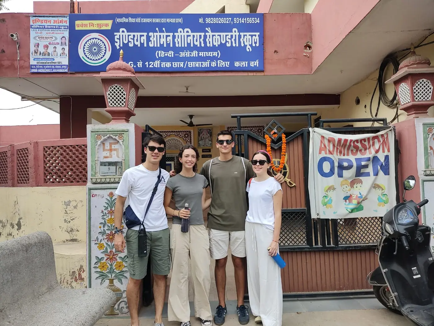 Group of young volunteers at the entrance of the free school in Jaipur, India
