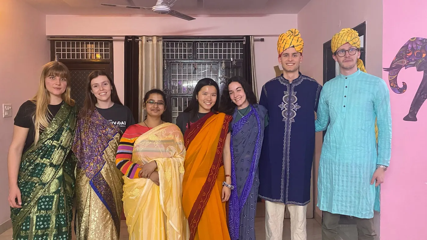 Young volunteers wearing traditional Indian clothing, sari and kurta